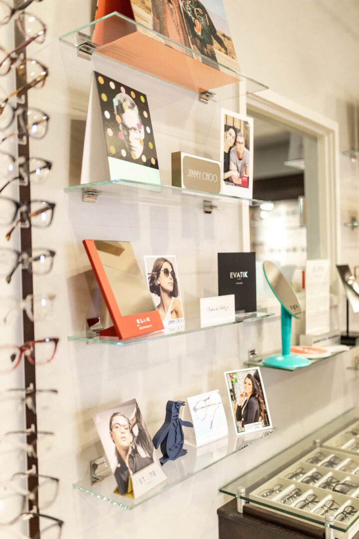 A display of glasses and frames on the wall.